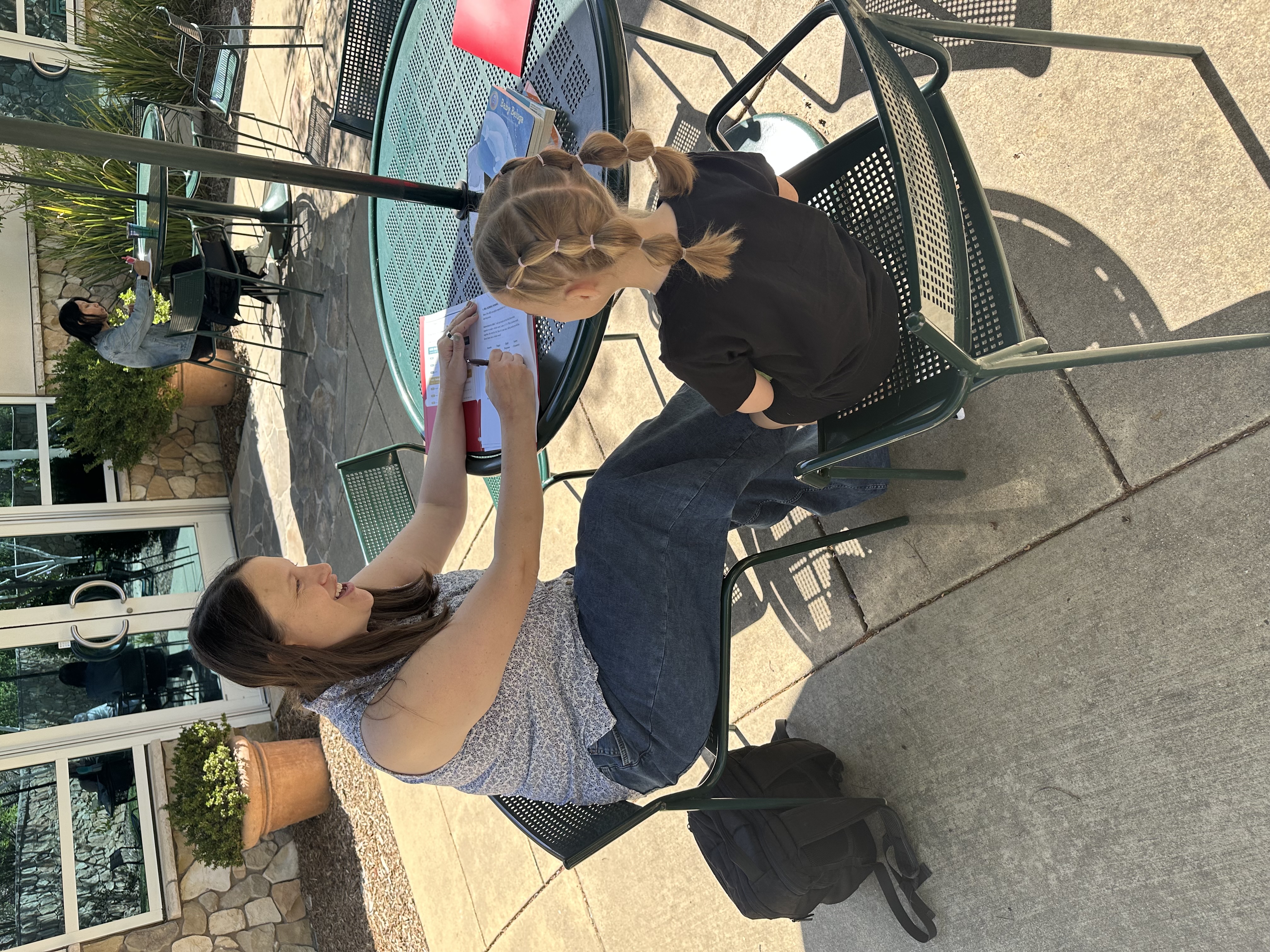 Kaitlyn working one on one with a child on reading skills